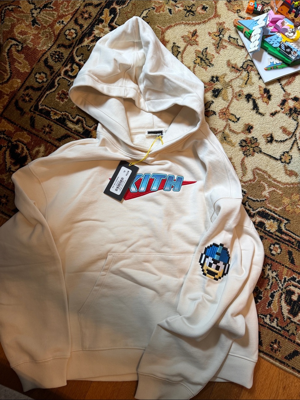 Kith Cream Hoodie with Blue Pixel Sleeve Patch